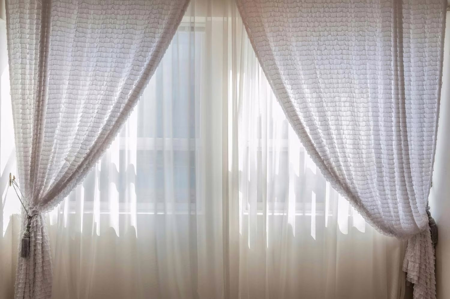 Sheer curtains on a bright window. 